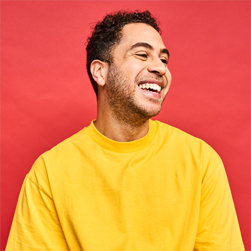 Michael Smiling on yellow background
